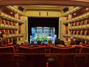 Penn State students at the Vienna State Opera House (Wiener Staatsoper) viewing a crew construct a set on stage from the center box seats